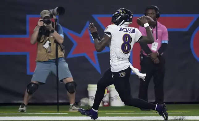 Baltimore Ravens quarterback Lamar Jackson (8) celebrates after a 48-yard touchdown run during the second half of an NFL football game against the Houston Texans, Wednesday, Dec. 25, 2024, in Houston. (AP Photo/David J. Phillip)