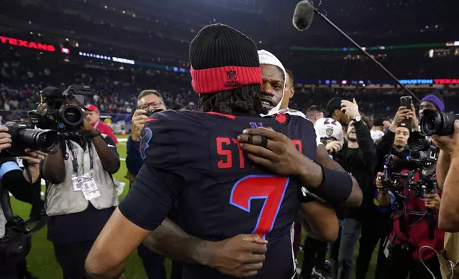 Houston Texans quarterback C.J. Stroud (7) hugs Baltimore Ravens quarterback Lamar Jackson after an NFL football game, Wednesday, Dec. 25, 2024, in Houston. (AP Photo/Eric Christian Smith)