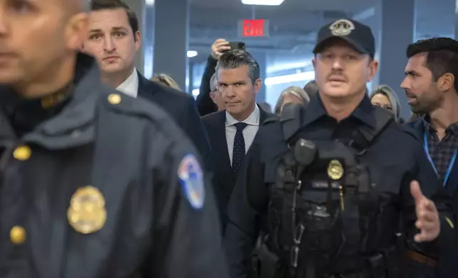 Pete Hegseth, President-elect Donald Trump's nominee to be defense secretary, walks through the basement of the Capitol, Wednesday, Dec. 4, 2024, in Washington. (AP Photo/Mark Schiefelbein)