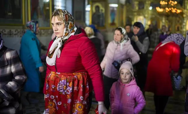 FILE - A woman leaves at the end of a religious service inside the Saint John the Baptist cathedral in Comrat, the capital of Gagauzia, an autonomous part of Moldova, Saturday, Nov. 2, 2024. (AP Photo/Vadim Ghirda, File)