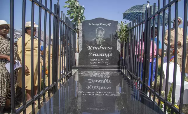 Friends and relatives of the Ziwangwe family, during the unveiling of the tombstone of late Kindness Ziwangwe at a cemetary in Harare, Zimbabwe, Saturday, Dec 7, 2024. (AP Photo/Aaron Ufumeli)