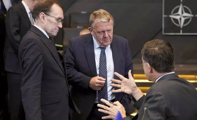 NATO Secretary General Mark Rutte, right, speaks with Denmark's Foreign Minister Lars Lokke Rasmussen, center, during a meeting of NATO foreign ministers at NATO headquarters in Brussels, Wednesday, Dec. 4, 2024. (AP Photo/Virginia Mayo)