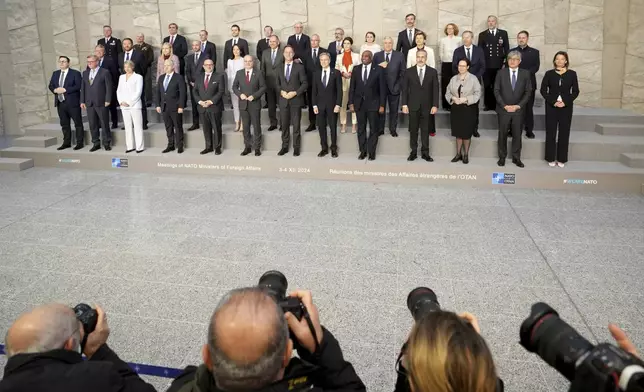 NATO foreign ministers pose for a group photo during a meeting of NATO foreign ministers at NATO headquarters in Brussels, Wednesday, Dec. 4, 2024. (AP Photo/Virginia Mayo)