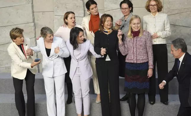 United States Secretary of State Antony Blinken, right, joins a group photo of from left, Latvia's Foreign Minister Baiba Braze, Canada's Foreign Minister Melanie Joly, Romania's Foreign Minister Luminita-Teodora Odobescu, Germany's Foreign Minister Annalena Baerbock, Iceland's Foreign Minister Thordis Kolbrun Reykfjord Gylfadottir, Slovenia's Foreign Minister Tanja Fajon, Sweden's Foreign Minister Maria Malmer Stenergard, Finland's Foreign Minister Elina Valtonen and NATO Deputy Secretary General Radmila Shekerinska during a meeting of NATO foreign ministers at NATO headquarters in Brussels, Wednesday, Dec. 4, 2024. (AP Photo/Virginia Mayo)