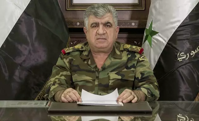 In this image from video provided by the Syrian official news agency SANA, Defense Minister Ali Abbas gives a televised statement about the fall of Bashar Assad’s government, Thursday, Dec. 5, 2024. (SANA via AP)