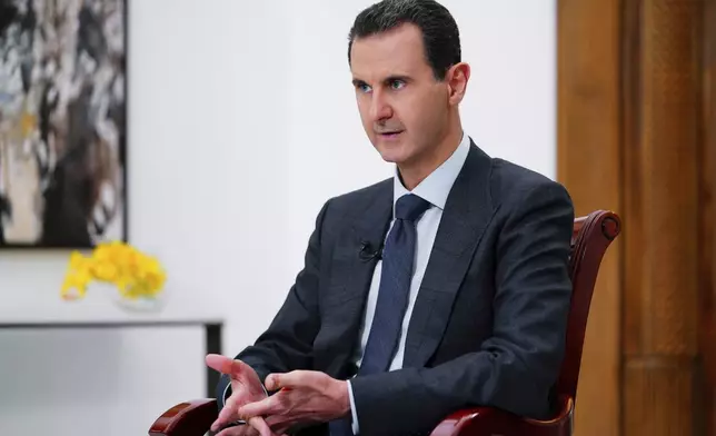 FILE - In this photo released Nov. 9, 2019, by the official news agency SANA, then-President Bashar Assad speaks in Damascus, Syria. (SANA FILE via AP, File)