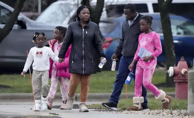 A family leaves the SSMI Health Center, set up as an reunification center, in Madison, Wis., following a shooting, Monday, Dec. 16, 2024. (AP Photo/Morry Gash)