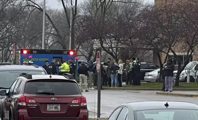 Emergency vehicles are parked outside of the SSM Health clinic where parents are being reunified with children after a shooting at the Abundant Life Christian School in Madison, Wis., Monday, Dec. 16, 2024. (AP Photo/Scott Bauer)