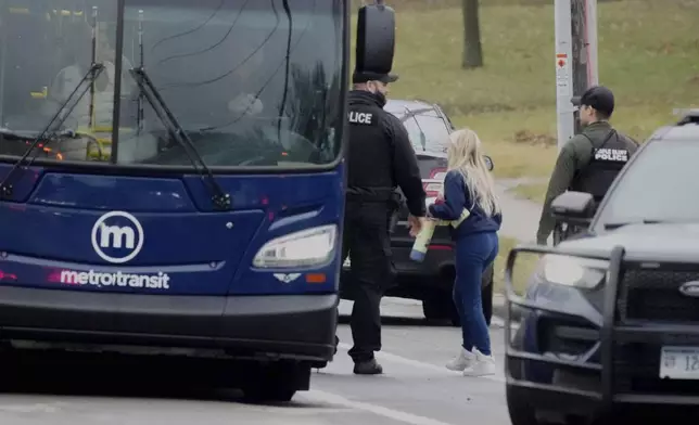 A student gets on a bus for the reunification center after multiple injuries were reported following a shooting at the Abundant Life Christian School, Monday, Dec. 16, 2024. (AP Photo/Morry Gash)