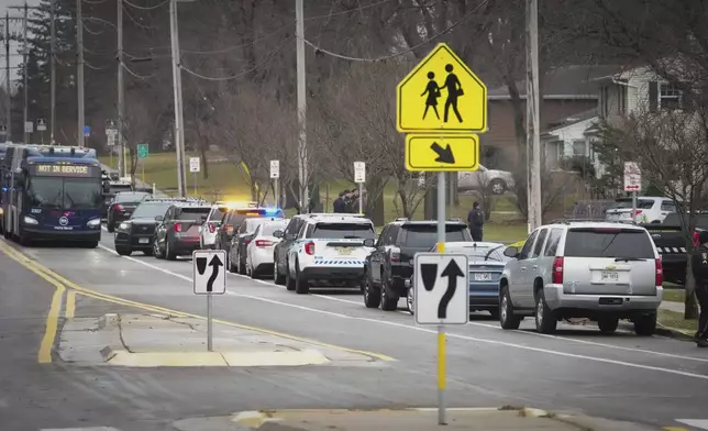 Emergency vehicles are staged outside the Abundant Life Christian School in Madison, Wis., where multiple injuries were reported following a shooting, Monday, Dec. 16, 2024. (AP Photo/Morry Gash)