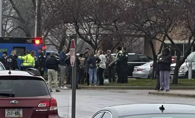 Emergency vehicles are parked outside of the SSM Health clinic where parents are being reunified with children after a shooting at the Abundant Life Christian School in Madison, Wis., Monday, Dec. 16, 2024. (AP Photo/Scott Bauer)