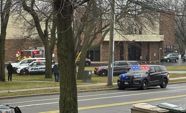 Emergency vehicles are parked outside the Abundant Life Christian School in Madison, Wis., where multiple injuries were reported following a shooting, Monday, Dec. 16, 2024. (AP Photo/Scott Bauer)