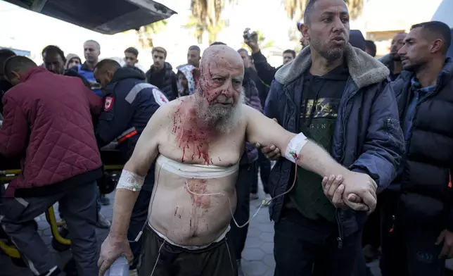 A Palestinian, wounded in the Israeli bombardment of the Gaza Strip, arrives at the Al-Aqsa Hospital in Deir al-Balah, Monday, Dec. 16, 2024. (AP Photo/Abdel Kareem Hana)