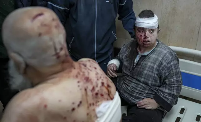 Palestinians, wounded in the Israeli bombardment of the Gaza Strip, receive treatment at the Al-Aqsa Hospital in Deir al-Balah, Monday, Dec. 16, 2024. (AP Photo/Abdel Kareem Hana)