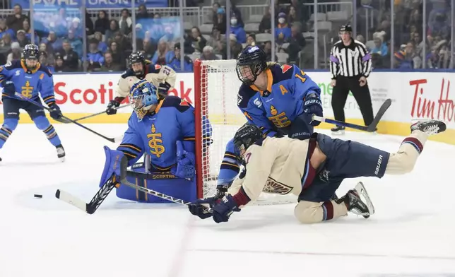 Montreal Victoire's Laura Stacey, bottom right, tries a wraparound against Toronto Sceptres goaltender Raygan Kirk, front left, during third-period PWHL hockey game action in Toronto, Saturday, Dec. 21, 2024. (Chris Young/The Canadian Press via AP)