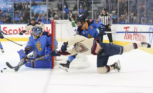 Montreal Victoire's Laura Stacey, bottom right, tries a wraparound against Toronto Sceptres goaltender Raygan Kirk, left, during third-period PWHL hockey game action in Toronto, Saturday, Dec. 21, 2024. (Chris Young/The Canadian Press via AP)