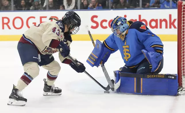 Toronto Sceptres goaltender Raygan Kirk saves a shot from Montreal Victoire's Kristen O'Neill during first period of a PWHL hockey game in Toronto, Saturday, Dec. 21, 2024. (Chris Young /The Canadian Press via AP)