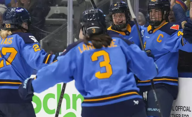 Toronto Sceptres' Izzy Daniel (8) celebrates after scoring her team's third goal against Montreal Victoire during the third period of a PWHL hockey game in Toronto, Saturday, Dec. 21, 2024. (Chris Young/The Canadian Press via AP)