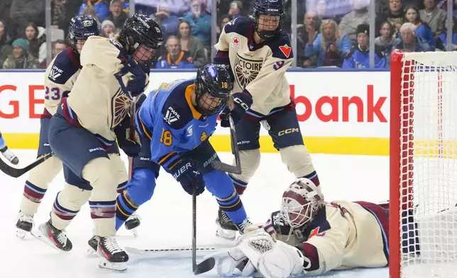 Toronto Sceptres' Izzy Daniel scores on Montreal Victoire goaltender Elaine Chuli during the third period of a PWHL hockey game in Toronto, Saturday, Dec. 21, 2024. (Chris Young/The Canadian Press via AP)