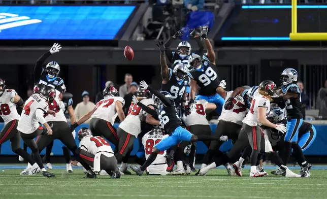 Tampa Bay Buccaneers place kicker Chase McLaughlin kicks the game winning field goal against the Carolina Panthers during overtime an NFL football game, Sunday, Dec. 1, 2024, in Charlotte, N.C. (AP Photo/Rusty Jones)