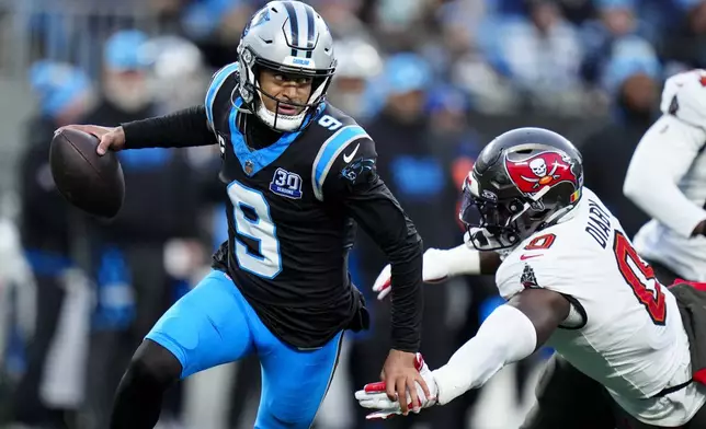 Carolina Panthers quarterback Bryce Young breaks away form Tampa Bay Buccaneers linebacker Yaya Diaby during the first half of an NFL football game, Sunday, Dec. 1, 2024, in Charlotte, N.C. (AP Photo/Rusty Jones)