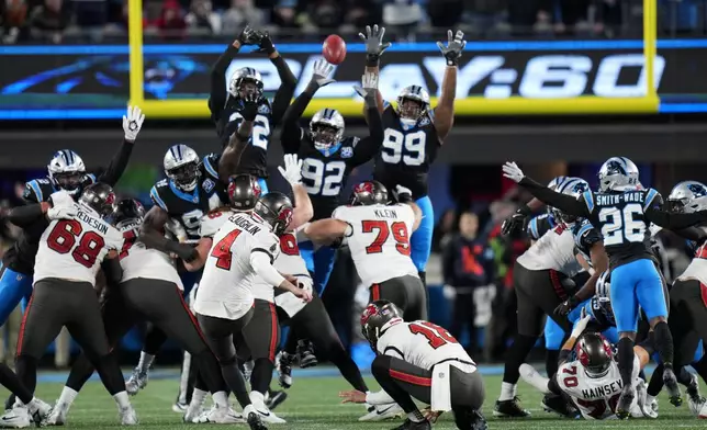 Tampa Bay Buccaneers place kicker Chase McLaughlin kicks a field goal to tie the game during the second half of an NFL football game against the Carolina Panthers, Sunday, Dec. 1, 2024, in Charlotte, N.C. (AP Photo/Rusty Jones)