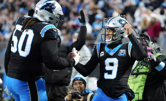 Carolina Panthers quarterback Bryce Young celebrates after scoring with guard Robert Hunt against the Tampa Bay Buccaneers during the first half of an NFL football game, Sunday, Dec. 1, 2024, in Charlotte, N.C. (AP Photo/Jacob Kupferman)