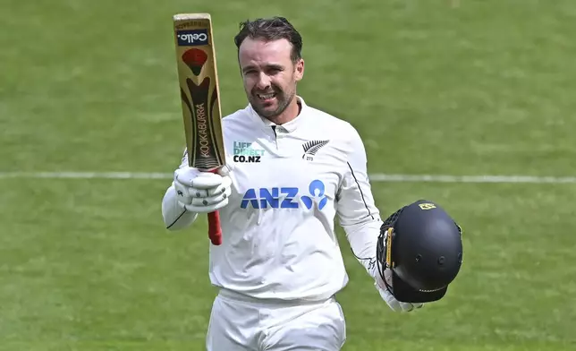 New Zealand's Tom Blundell celebrates after scoring a century during play on day three of the second cricket test between New Zealand and England at the Basin Reserve in Wellington, New Zealand, Sunday, Dec.8, 2024. (Kerry Marshall/Photosport via AP)