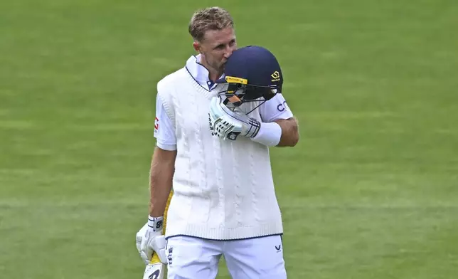 England's Joe Root reacts after scoring a century during play on day three of the second cricket test between New Zealand and England at the Basin Reserve in Wellington, New Zealand, Sunday, Dec.8, 2024. (Kerry Marshall/Photosport via AP)