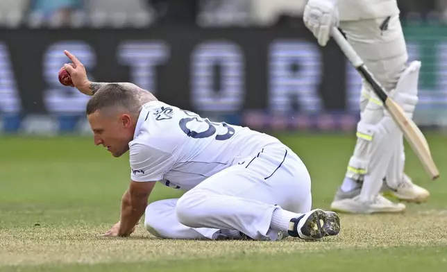 England's Brydon Carse reacts to catching New Zealand's Tom Latham during play on day three of the second cricket test between New Zealand and England at the Basin Reserve in Wellington, New Zealand, Sunday, Dec.8, 2024. (Kerry Marshall/Photosport via AP)