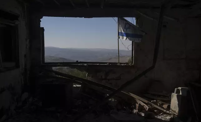 A view of Lebanese village through a window of a damaged house that was hit by a rocket fired from Lebanon, in the Kibbutz Manara, located in the upper Galilee, northern Israel, Monday Dec. 2, 2024. (AP Photo/Ohad Zwigenberg)