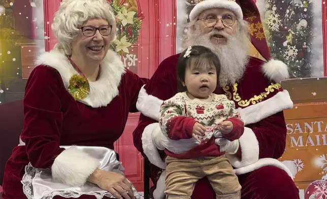 Santa and Mrs. Claus talk to a child in Yakutat, Alaska, in the Alaska National Guard's Operation Santa program, Wednesday, Dec. 18, 2024. (AP Photo/Mark Thiessen)