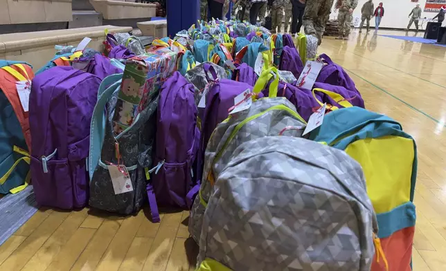 Backpacks filled with gifts wait to be given to children in Yakutat, Alaska, in the Alaska National Guard's Operation Santa program, Wednesday, Dec. 18, 2024. (AP Photo/Mark Thiessen)