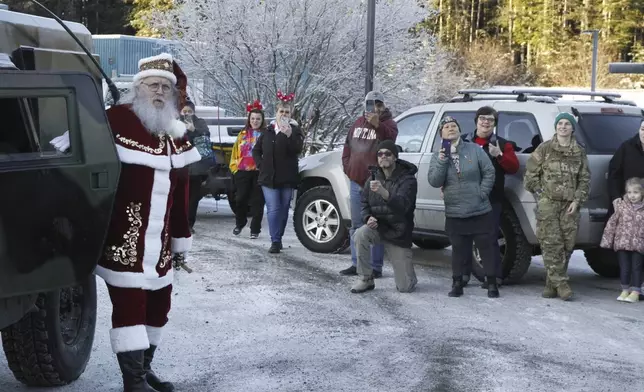 Santa Claus arrives at the school in Yakutat, Alaska,, as part of the Alaska National Guard's Operation Santa initiative that brings Christmas to an Indigenous community that has suffered a hardship, Wednesday, Dec. 18, 2024. (AP Photo/Mark Thiessen).