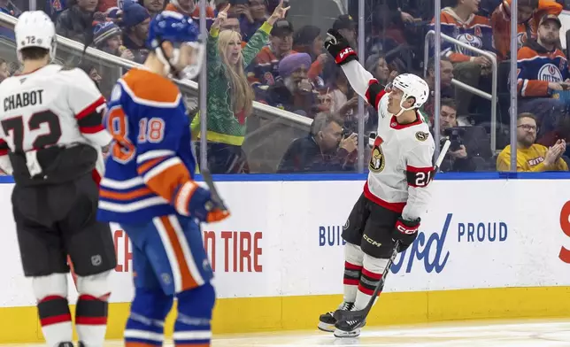 Ottawa Senators' Nick Cousins (21) celebrates after his goal against the Edmonton Oilers during second-period NHL hockey game action in Edmonton, Alberta, Sunday, Dec. 22, 2024. (Timothy Matwey/The Canadian Press via AP)