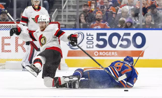 Ottawa Senators' Nick Jensen (3) collides with Edmonton Oilers' Connor McDavid (97) during third-period NHL hockey game action in Edmonton, Alberta, Sunday, Dec. 22, 2024. (Timothy Matwey/The Canadian Press via AP)