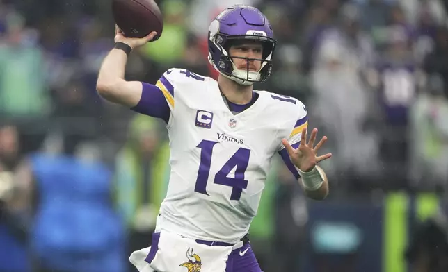 Minnesota Vikings quarterback Sam Darnold (14) passes during the first half of an NFL football game against the Seattle Seahawks, Sunday, Dec. 22, 2024, in Seattle. (AP Photo/Lindsey Wasson)