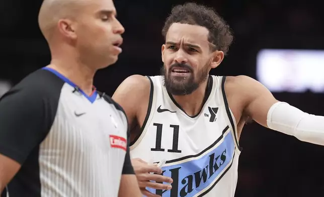 Atlanta Hawks guard Trae Young (11) talks with an official in the first half of an NBA basketball game against the Los Angeles Lakers, Friday, Dec. 6, 2024, in Atlanta. (AP Photo/Brynn Anderson)