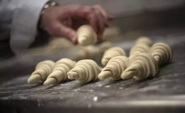 French baker Arnaud Delmontel bakes butter croissants in Paris, Monday, Dec. 16, 2024 as butter has shot up in price across Europe in recent months, adding more pain to consumers this holiday season after years of inflation in the wake of the COVID-19 pandemic and war in Ukraine.(AP Photo/Aurelien Morissard)