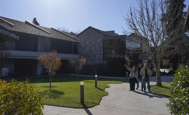 People walk at the Merom Golan Volcano Resort inside the kibbutz of Meron Golan in the Israeli-annexed Golan Heights, which most of the world considers occupied Syrian territory, Thursday, Dec. 19, 2024. (AP Photo/Matias Delacroix)