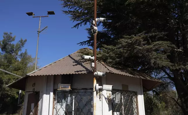 Security cameras cover a pole at the entrance of the kibbutz of Ein Zivan in the Israeli-annexed Golan Heights, which most of the world considers occupied Syrian territory, Thursday, Dec. 19, 2024. (AP Photo/Matias Delacroix)