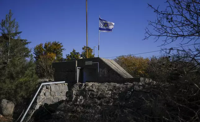 An Israeli flag flies on top of the entrance of a bomb shelter in the kibbutz of Ein Zivan in the Israeli-annexed Golan Heights, which most of the world considers occupied Syrian territory, Thursday, Dec. 19, 2024. (AP Photo/Matias Delacroix)