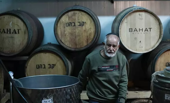 Elyaho Abo works at the Bahat winery in the kibbutz of Ein Zivan in the Israeli-annexed Golan Heights, which most of the world considers occupied Syrian territory, Thursday, Dec. 19, 2024. (AP Photo/Matias Delacroix)