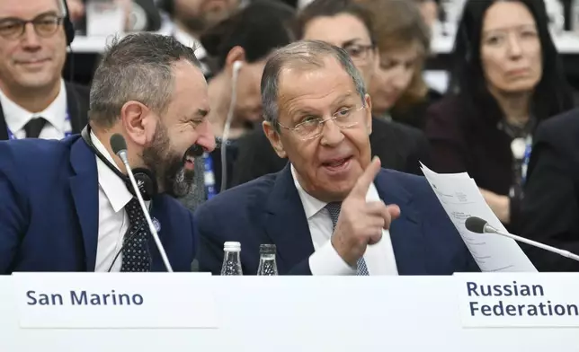Russia's Foreign Minister Sergei Lavrov, right, flanked by San Marino's Secretary of State for Foreign Affairs Luca Beccari speak, during a plenary session of the 31st Organization for Security and Cooperation in Europe (OSCE) Ministerial summit, in Ta'Qali, Malta, Thursday, Dec. 5, 2024. (Alberto Pizzoli/Pool Photo via AP)