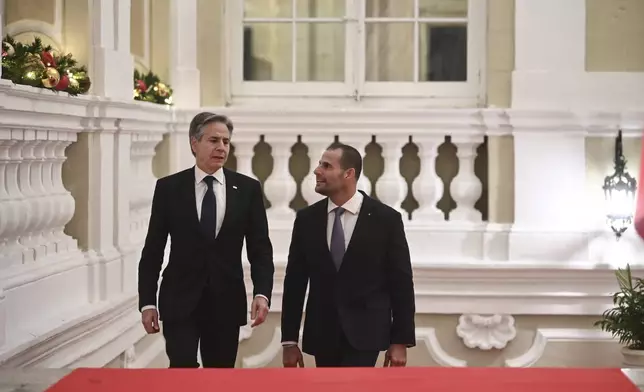U.S. Secretary of State Antony Blinken, left, and Maltese Prime Minister Robert Abela arrive at the Auberge de Castille for bilateral talks, in Valletta, Malta, Wednesday, Dec. 4, 2024. (AP Photo/Jonathan Borg, Pool)