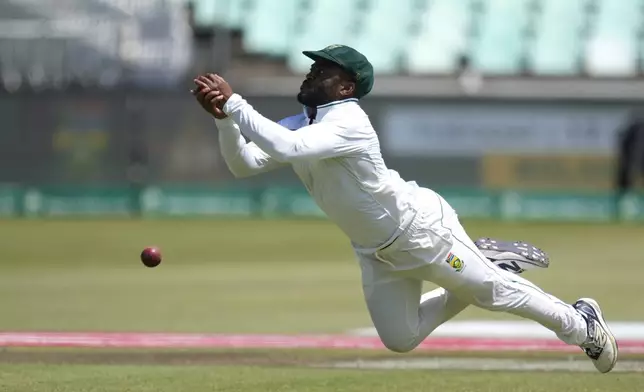 South Africa's captain Temba Bavuma misses a catch during the fourth day of the first Test cricket match between South Africa and Sri Lanka, at Kingsmead stadium in Durban, South Africa, Saturday, Nov. 30, 2024. (AP Photo/Themba Hadebe)