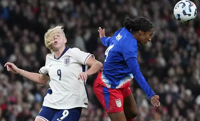 England's Alessia Russo, left, and United States' Naomi Girma challenge for the ball during the International friendly women soccer match between England and United States at Wembley stadium in London, Saturday, Nov. 30, 2024. (AP Photo/Kirsty Wigglesworth)