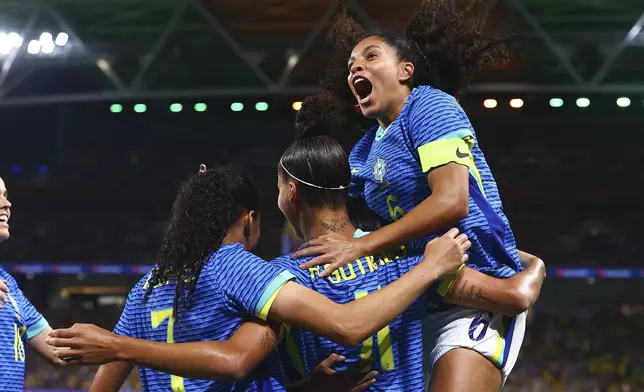 Brazil's Amanda Gutierres, second right, is congratulated by teammate Yasmin, right, after scoring her team's first goal during a soccer international between Brazil and Australia in Brisbane, Australia, Thursday, Nov. 28, 2024. (AP Photo/Pat Hoelscher)