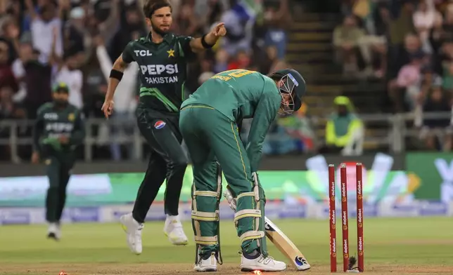 Pakistan bowler Shaheen Afridi celebrates while South Africa's Marco Jansen stares at his fallen wickets during the second ODI International cricket match between South Africa and Pakistan in Cape Town, South Africa, Thursday, Dec. 19, 2024. (AP Photo/Halden Krog)