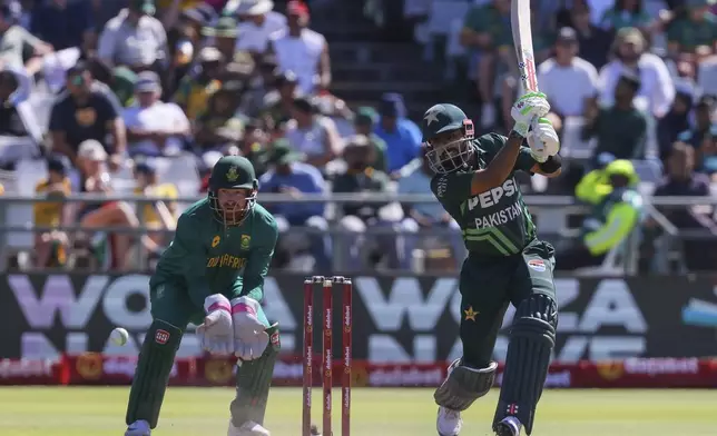 South African wicketkeeper Heinrich Klaasen, left, watches as Pakistans Babar Aam plays a shot during the second ODI International cricket match between South Africa and Pakistan in Cape Town, South Africa, Thursday, Dec. 19, 2024. (AP Photo/Halden Krog)